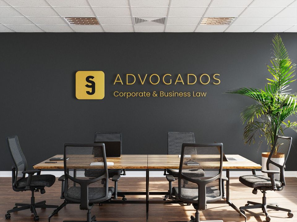 Meeting room with SJ Advogados Lda branding in gold and charcoal